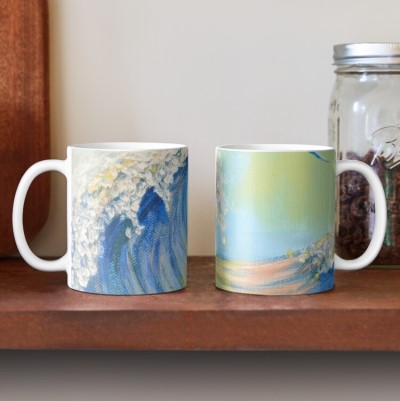 BY THE SEA classic mug - Sandra Burns ART - nature art mug for sale, looking along the curl of a wave, with pink and yellow reflections on the water, white splashes of water on the crest of the wave, and a seagull flying alongside, blue, green, yellow, pink, water, wave, sea, splash, surf, sky, seagull, summertime, memories of summer